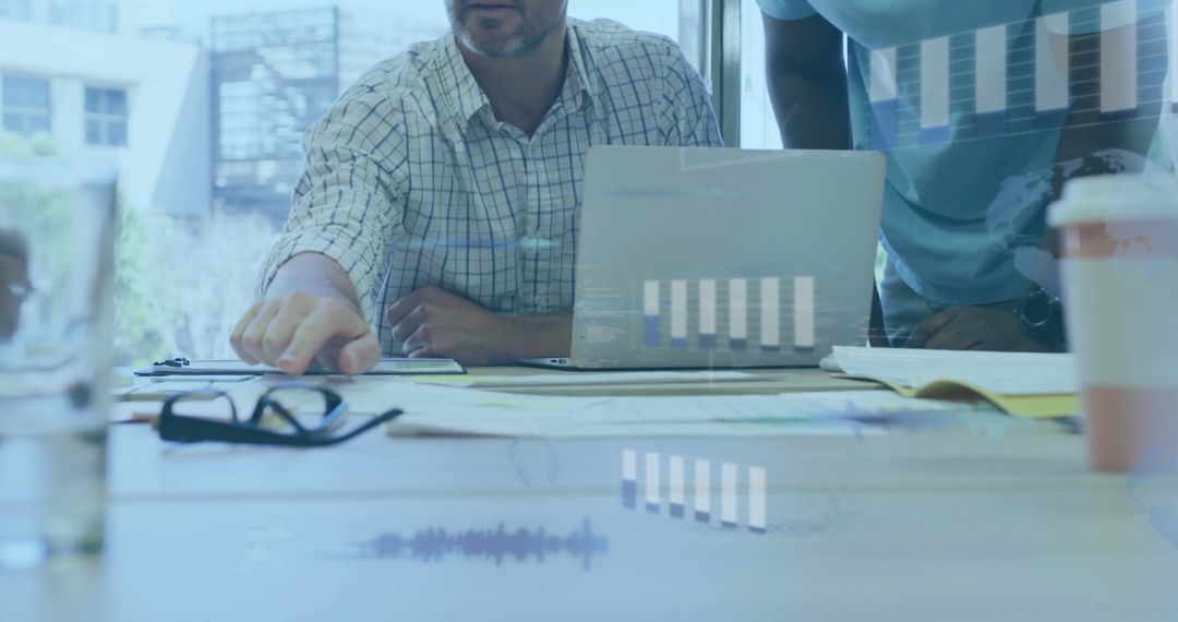 Team Analyzing Financial Data with Charts and Graphs Projected