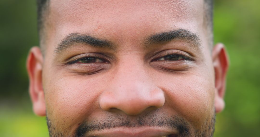 Smiling African American Man Against Lush Vegetation