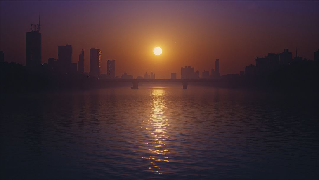 Sunlit Urban River with Silhouette Skyline