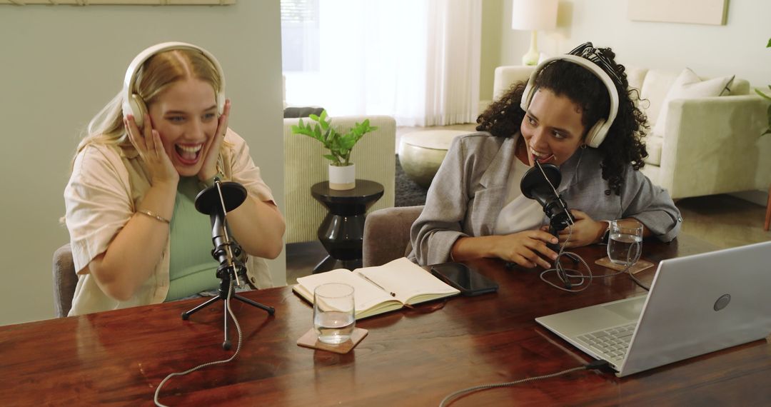 Two Engaged Women Hosting a Podcast Together with Microphones
