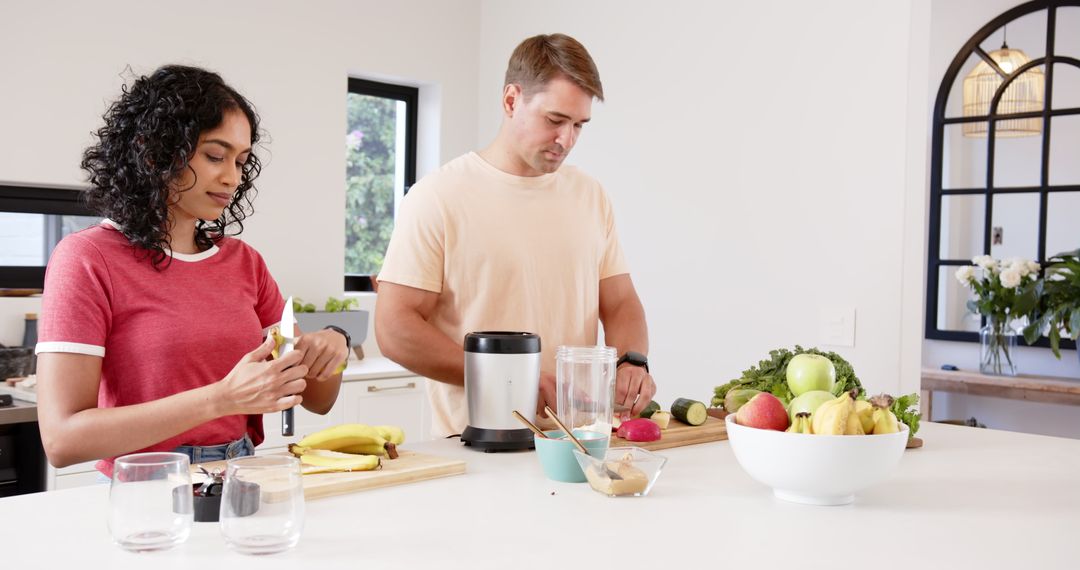 Couple Preparing Nutritious Fruit and Vegetable Blender Drinks in Modern Kitchen
