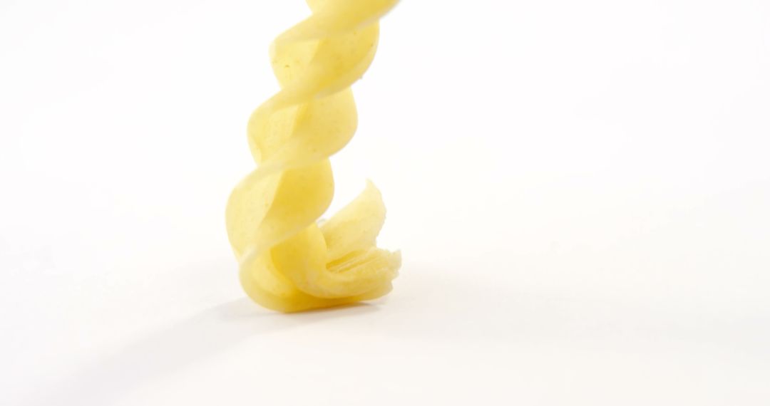 Close-Up of Single Uncooked Fusilli Pasta on White Background - Free Images, Stock Photos and Pictures on Pikwizard.com