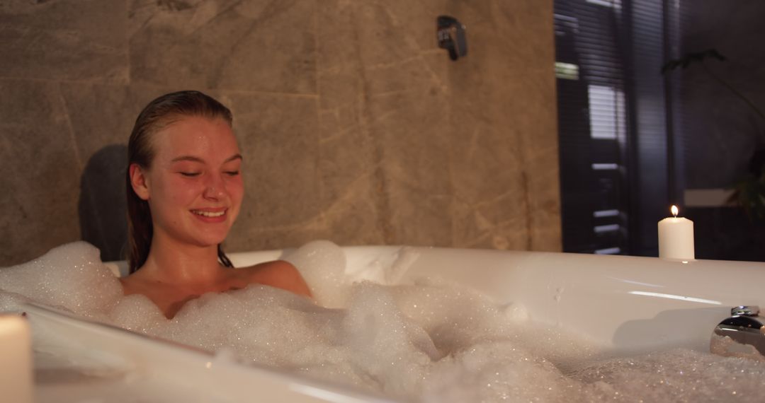 Young Woman Relaxing in Bubble Bath with Candles - Free Images, Stock Photos and Pictures on Pikwizard.com