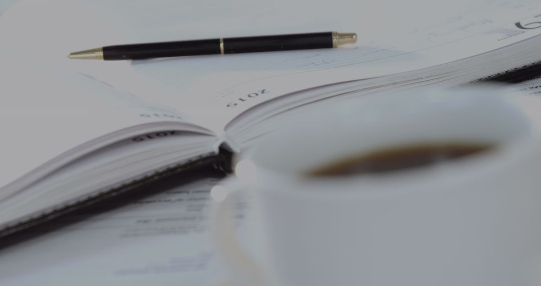 Coffee Break with Business Planner and Pen