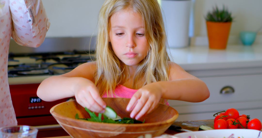 Young Girl Making Fresh Salad in Modern Kitchen - Free Images, Stock Photos and Pictures on Pikwizard.com