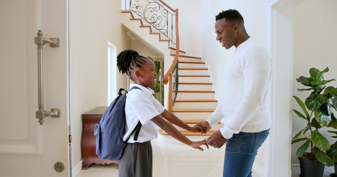 Joyful Father Greeting Daughter Returning from School
