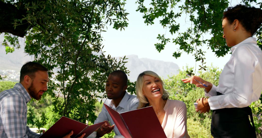 Diverse Group Enjoying Outdoor Meal in Nature Restaurant - Free Images, Stock Photos and Pictures on Pikwizard.com