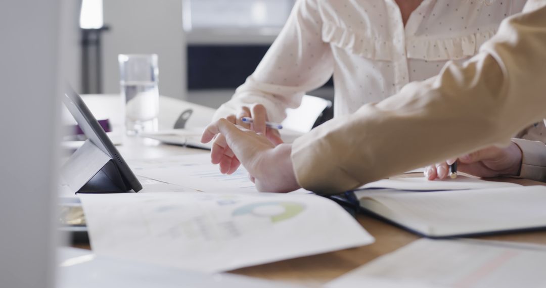 Collaborative Meeting with Digital Tablet at Workplace