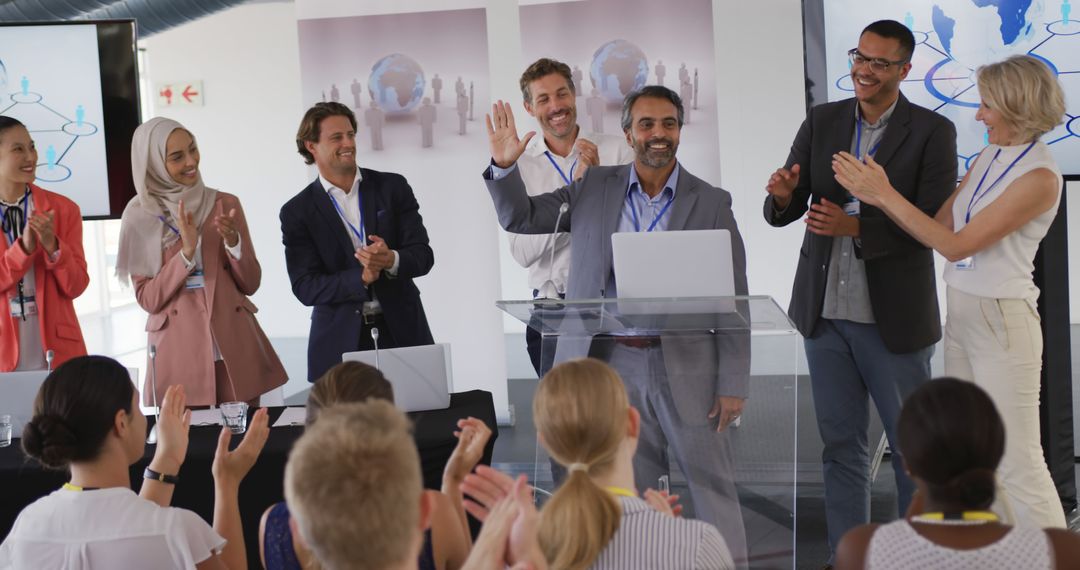 Diverse team clapping for speaker at podium, mentor holding tablet - Free Images, Stock Photos and Pictures on Pikwizard.com