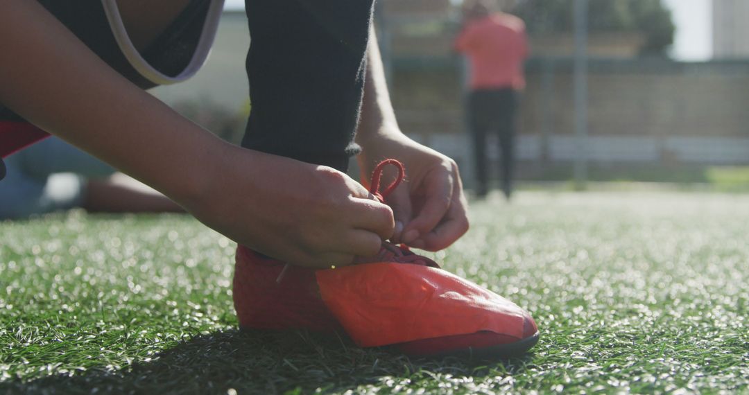 Youth Soccer Player Tying Soccer Cleats on Field - Free Images, Stock Photos and Pictures on Pikwizard.com