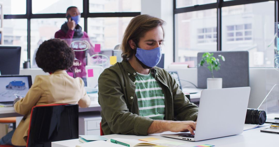 Business Team Working with Face Masks in Modern Office Environment