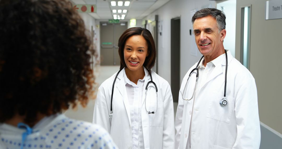 Medical professionals of varied ethnicities engage positively with a patient in a hospital. - Free Images, Stock Photos and Pictures on Pikwizard.com