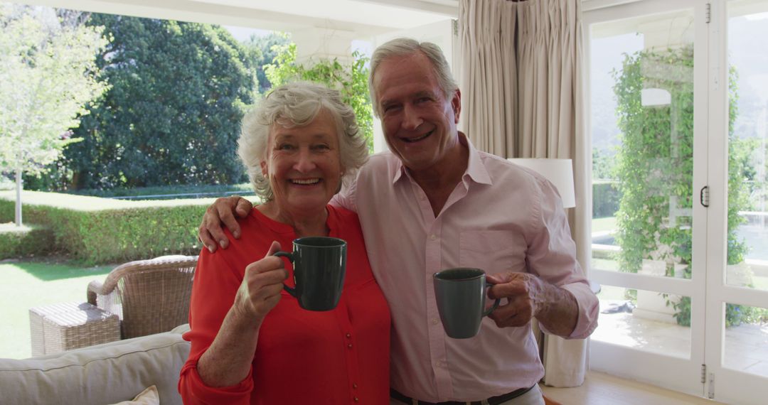 Happy Senior Couple Enjoying Coffee Together in Sunny Living Room - Free Images, Stock Photos and Pictures on Pikwizard.com