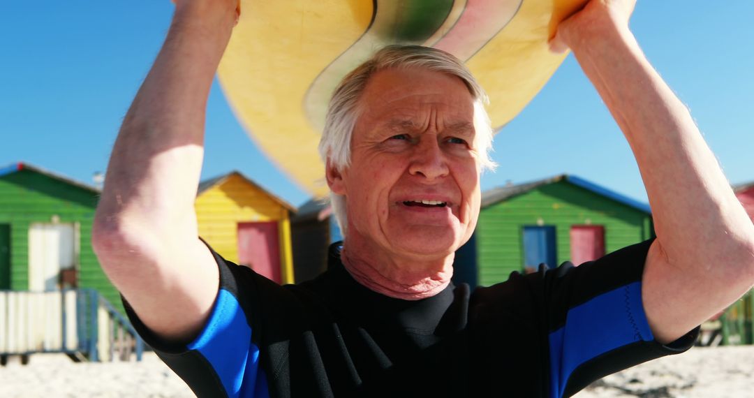 Senior Man Carries Surfboard At Colorful Beach - Free Images, Stock Photos and Pictures on Pikwizard.com