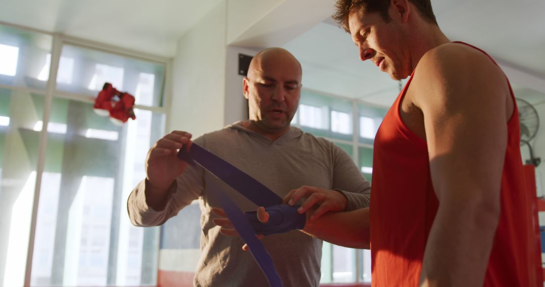 Trainer Helping Man Wrap Hands for Boxing Training in Gym - Free Images, Stock Photos and Pictures on Pikwizard.com