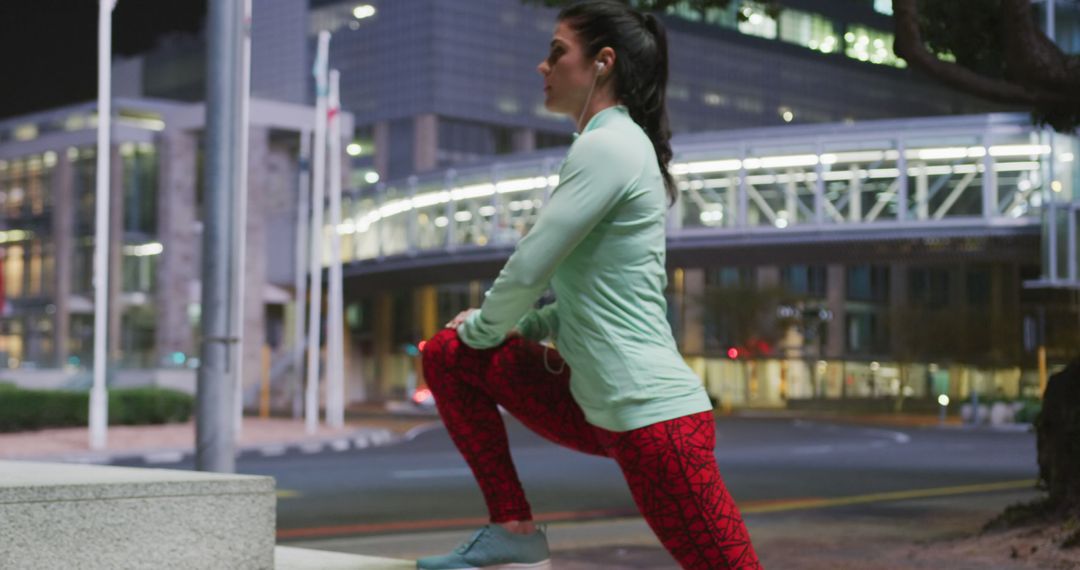 Fit Woman Stretching Outdoors at Night Near Office Buildings - Free Images, Stock Photos and Pictures on Pikwizard.com