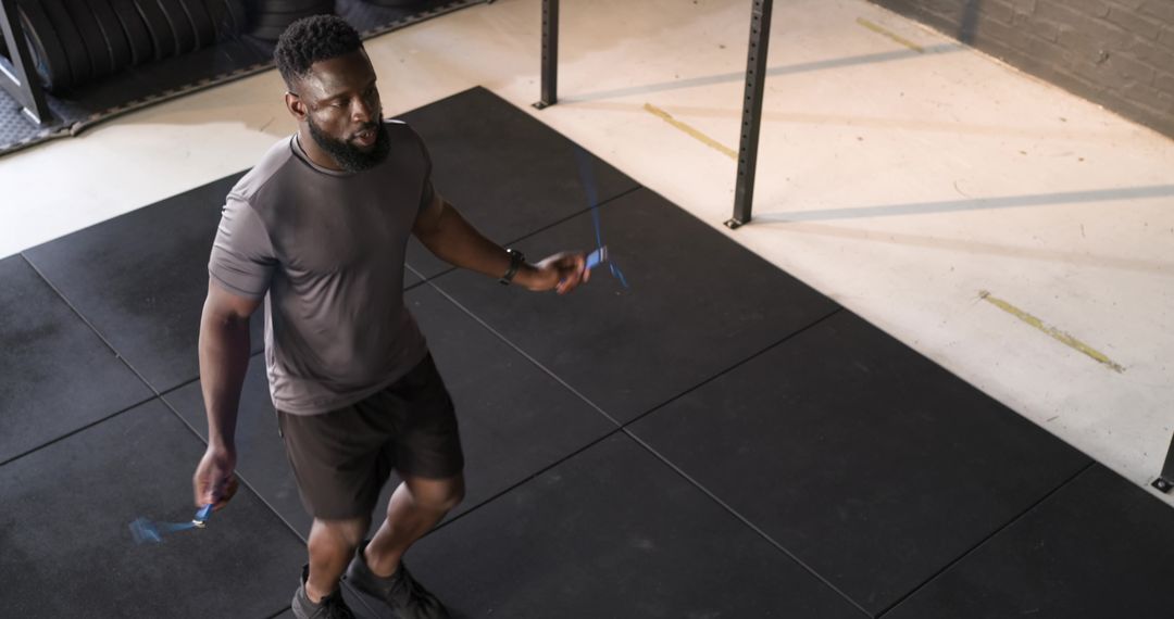 Man Jumping Rope in Minimalist Gym Setting for Cardio Training