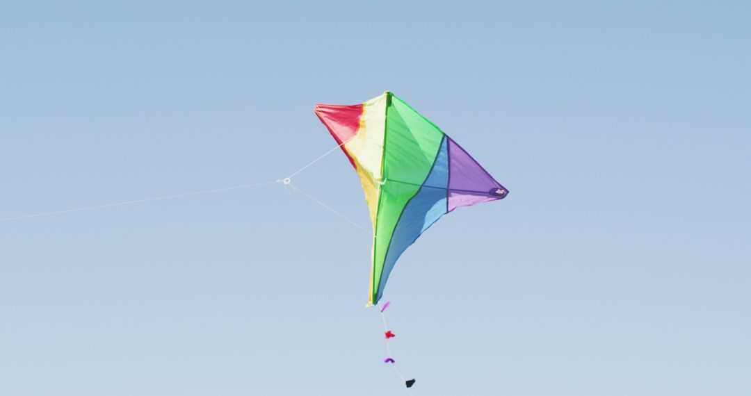 Colorful Kite Flying Against Clear Blue Sky - Free Images, Stock Photos and Pictures on Pikwizard.com