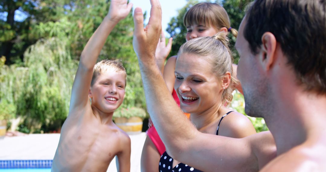 Family Enjoying Sunny Poolside High-Five Celebration - Free Images, Stock Photos and Pictures on Pikwizard.com