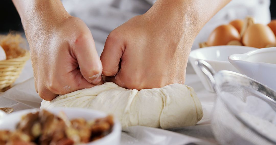 Hands Kneading Dough on Flour-Covered Counter for Baking