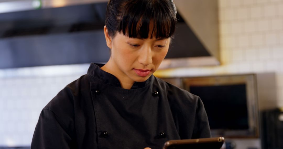 Professional Chef Using Smartphone in Commercial Kitchen - Free Images, Stock Photos and Pictures on Pikwizard.com