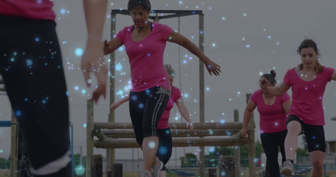 Group of Women Conquering Obstacles in Bootcamp Training