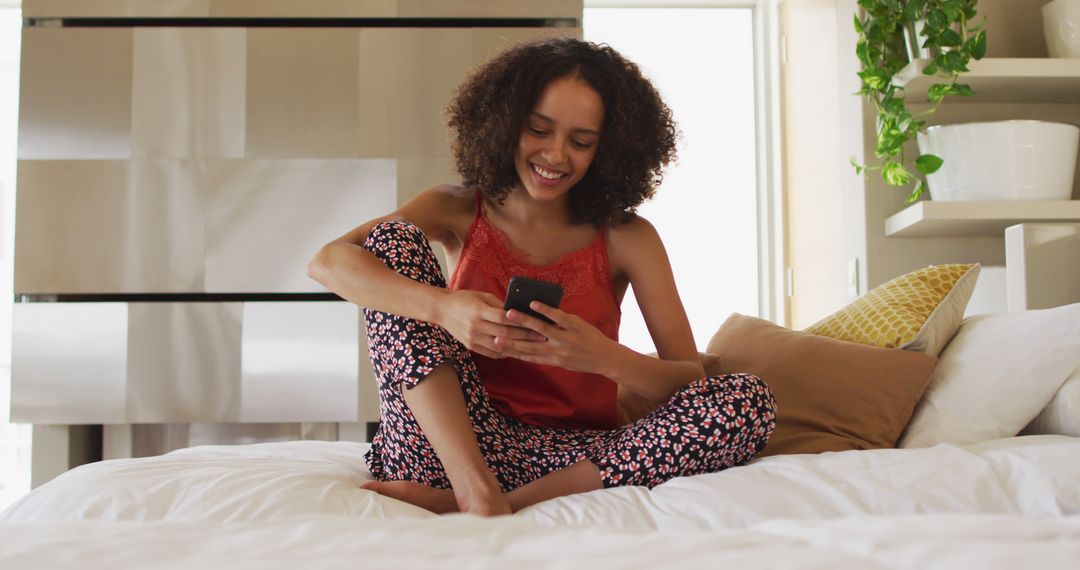 Young Woman Relaxing in Bed Using Smartphone - Free Images, Stock Photos and Pictures on Pikwizard.com