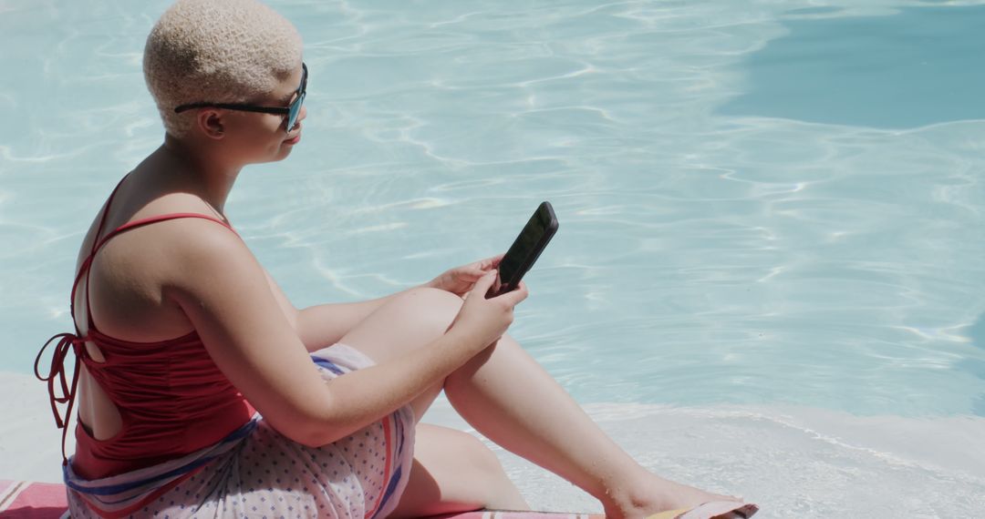 Woman Reading Smartphone near Bright Pool on Sunny Day - Free Images, Stock Photos and Pictures on Pikwizard.com