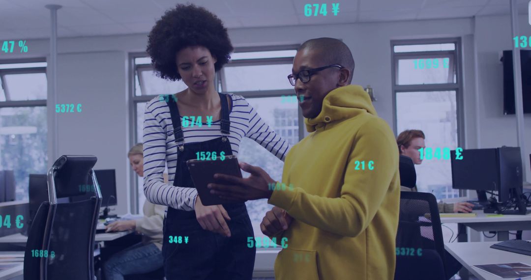 Diverse Team Analyzing Data on Tablet in Modern Office Environment