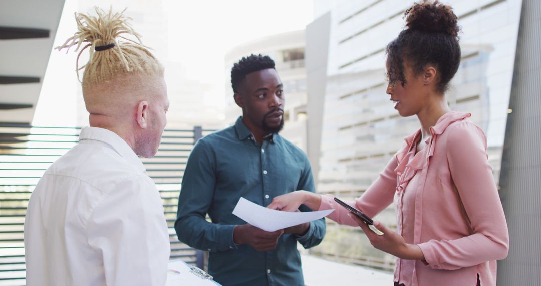 Diverse Team Collaborating on Project in Modern Office Outdoors