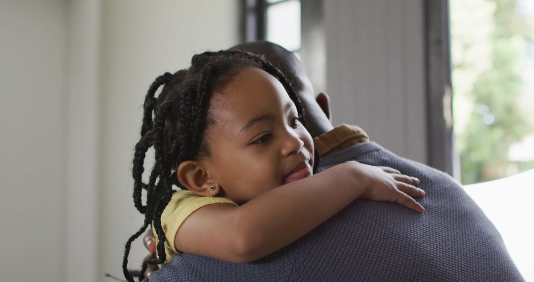 Father and Daughter Embracing at Home Bringing Joyful Connection