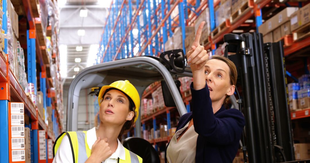 Warehouse Supervisor Instructing Worker in Warehouse Aisles - Free Images, Stock Photos and Pictures on Pikwizard.com