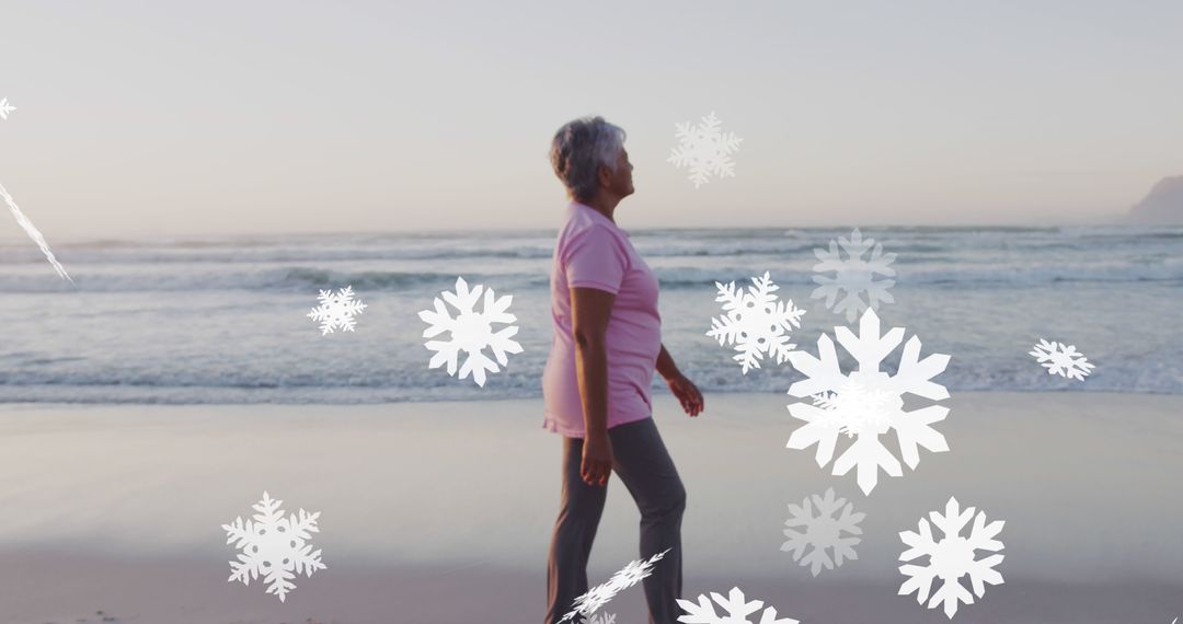 Senior Woman Walking on Beach with Digital Snowflakes - Free Images, Stock Photos and Pictures on Pikwizard.com