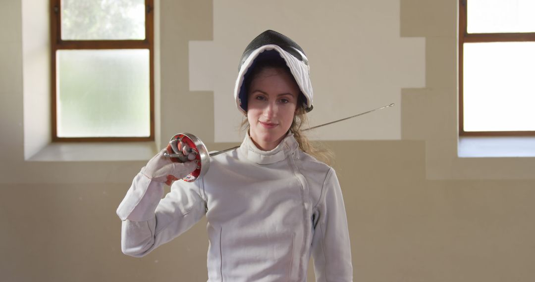 Female Fencer Holding Foil Saber in Training Hall - Free Images, Stock Photos and Pictures on Pikwizard.com