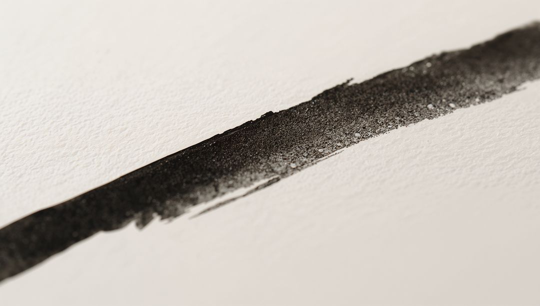 Slanted Black Ink Stroke Showing Pigment Grain and Paper Texture, Minimalist Abstract