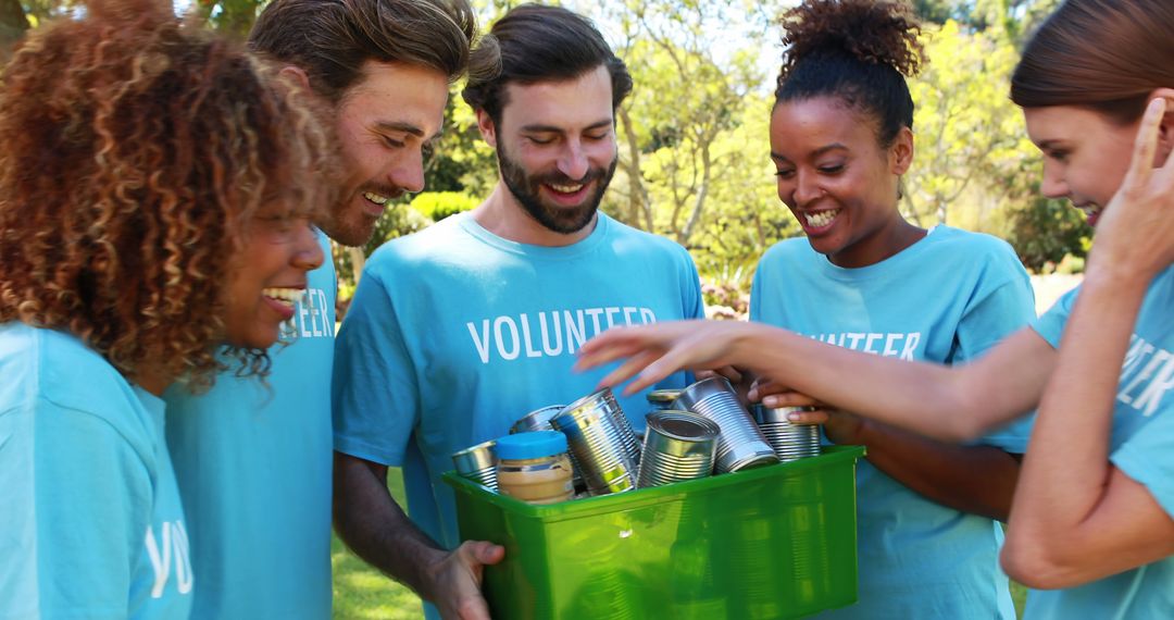 Diverse Volunteers Sorting Donations in Park on Sunny Day - Free Images, Stock Photos and Pictures on Pikwizard.com