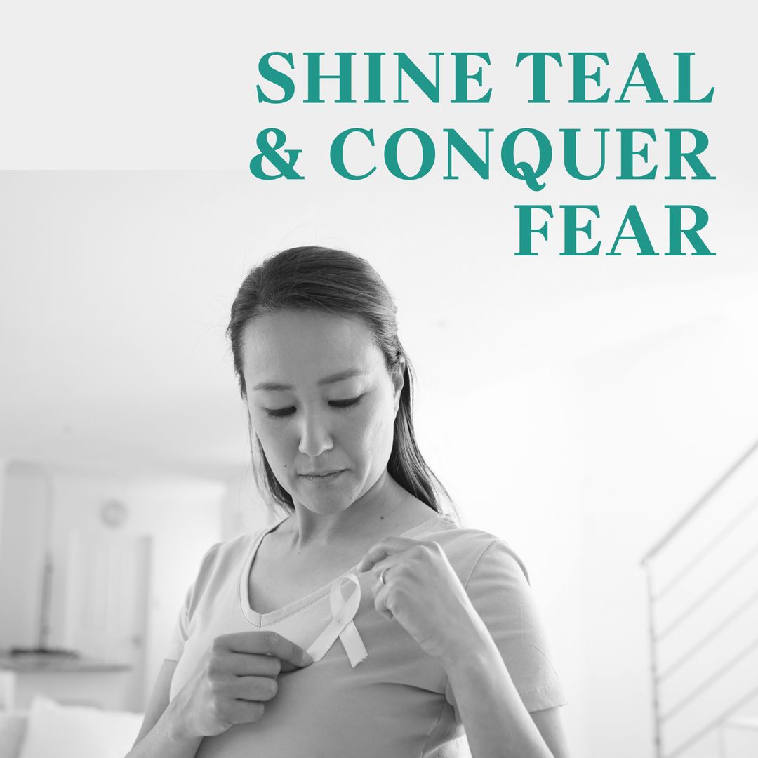 Asian Woman Placing Cancer Awareness Ribbon on Shirt