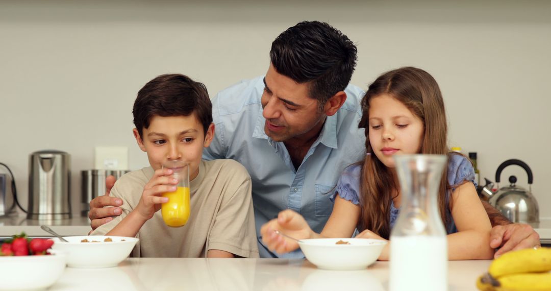 Father and Children Enjoying Breakfast in Kitchen - Free Images, Stock Photos and Pictures on Pikwizard.com