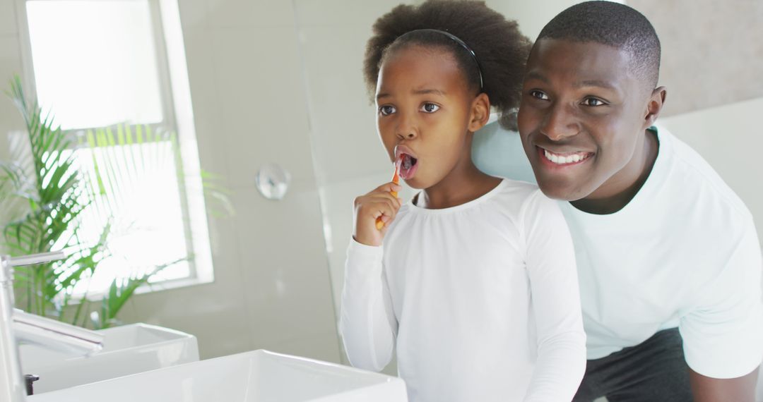 Father Helping Daughter Brush Teeth in Bathroom - Free Images, Stock Photos and Pictures on Pikwizard.com