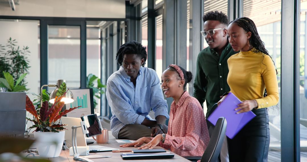 Team Analyzing Data on Computer in Modern Office