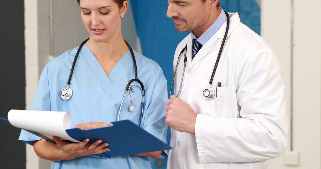 Medical Professionals Reviewing Patient Files in Hospital - Free Images, Stock Photos and Pictures on Pikwizard.com