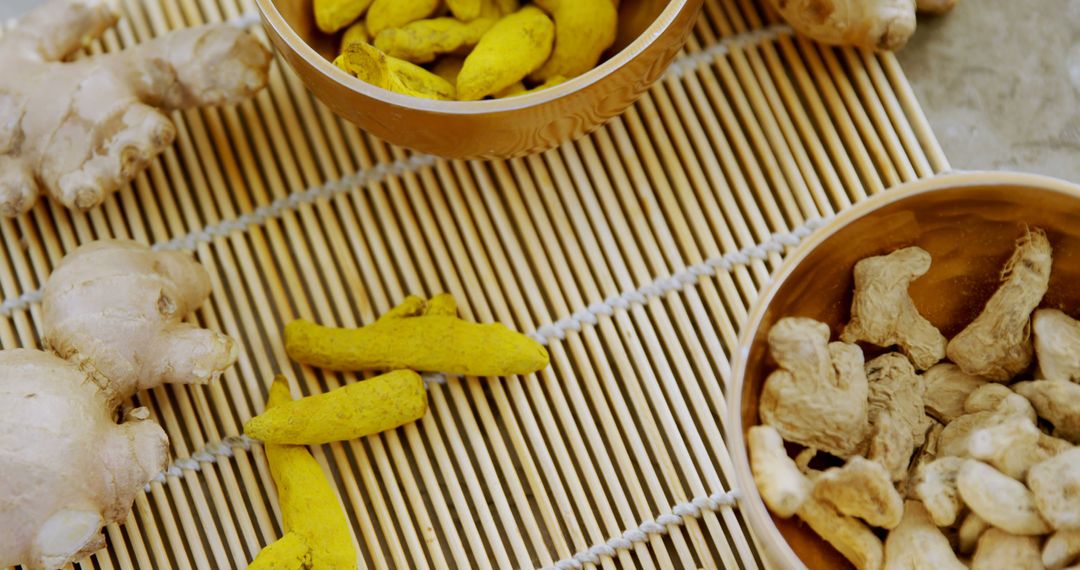 Fresh Ginger Roots and Dried Turmeric on Bamboo Mat