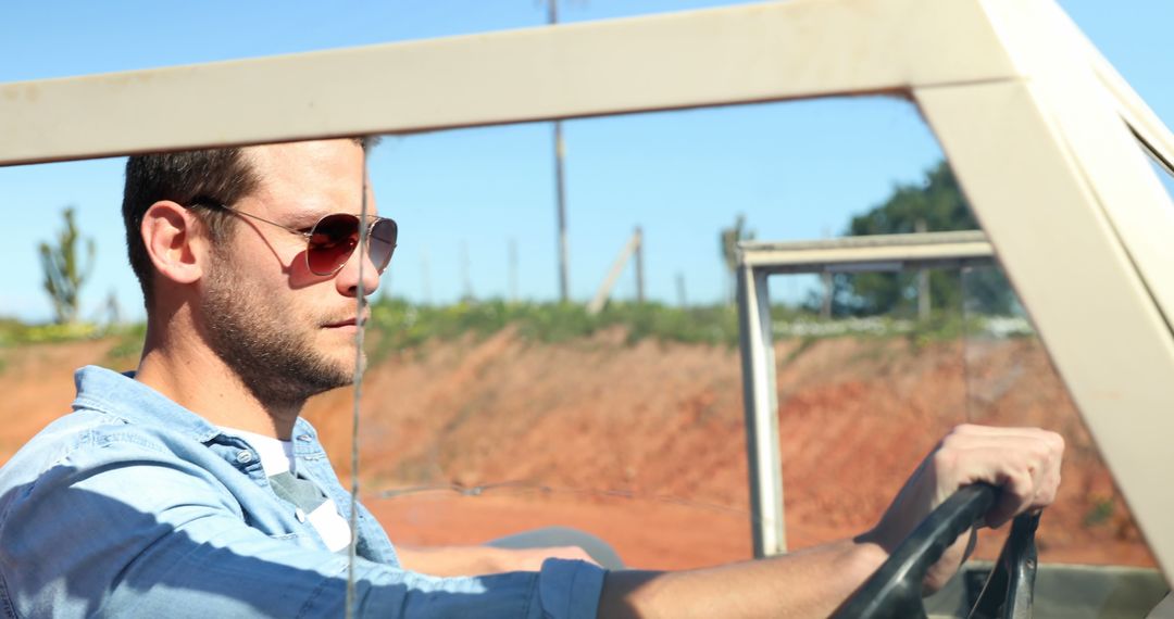 Man Driving Convertible on Countryside Road on Sunny Day - Free Images, Stock Photos and Pictures on Pikwizard.com