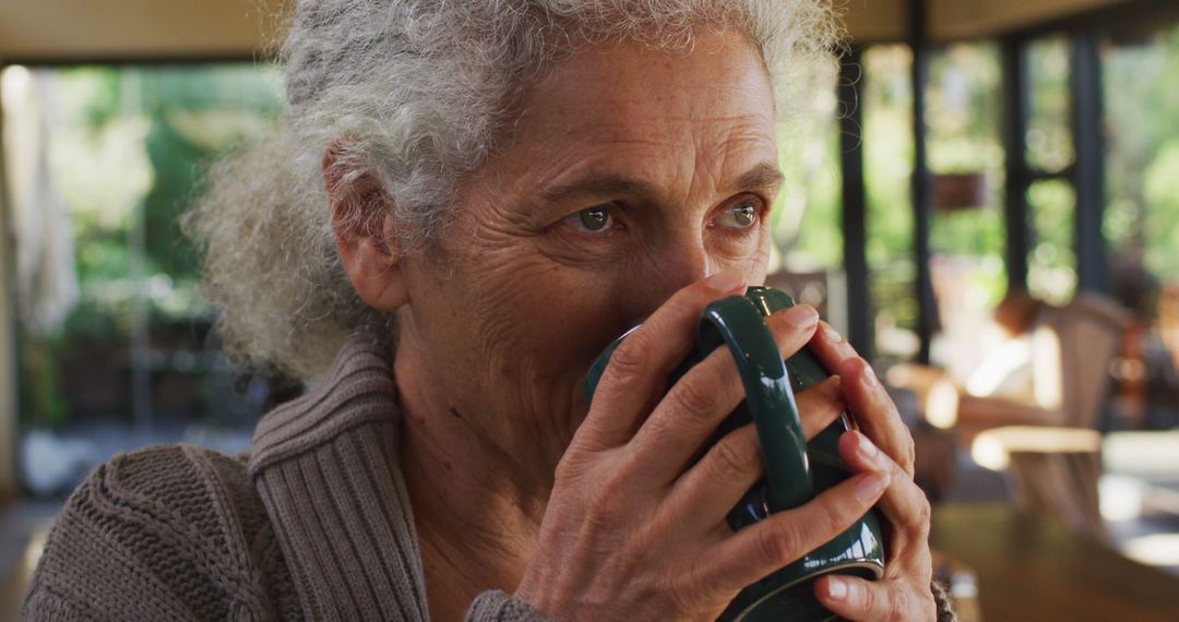 Senior Woman Enjoying Warm Beverage in Cozy Home - Free Images, Stock Photos and Pictures on Pikwizard.com