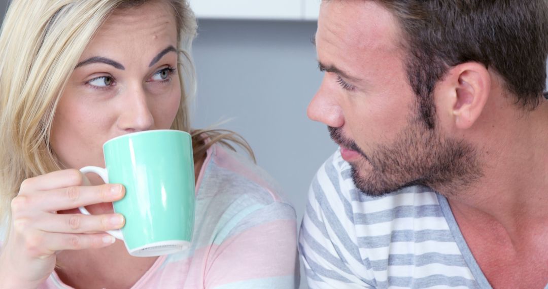 Cute couple drinking coffee together in the kitchen - Free Images, Stock Photos and Pictures on Pikwizard.com