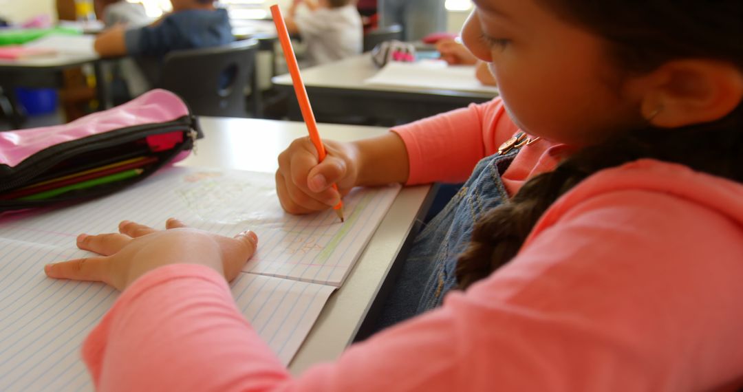 Young Schoolgirl Focused on Classroom Writing Activity