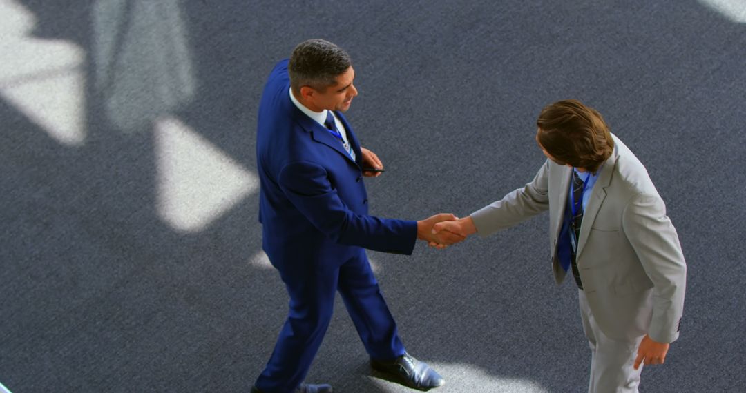 High Angle View of Businessmen Shaking Hands in Office Interaction