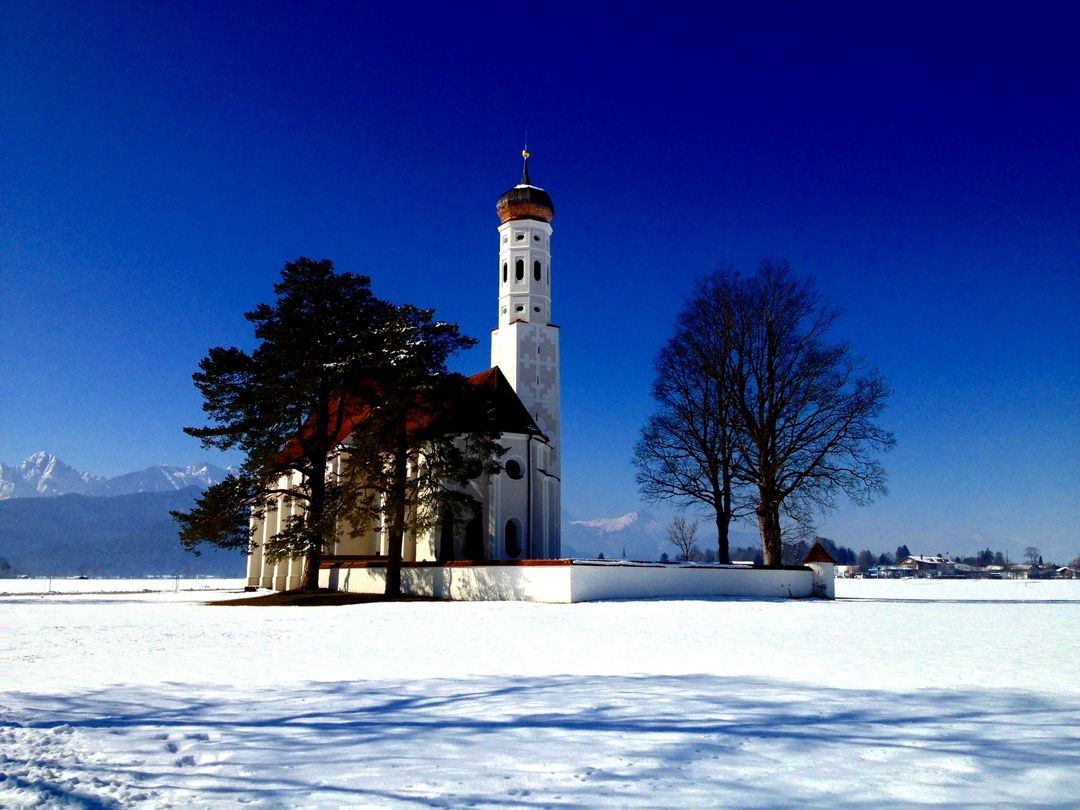 Scenic Snow-Covered Landscape with Historic Church and Blue Sky - Free Images, Stock Photos and Pictures on Pikwizard.com