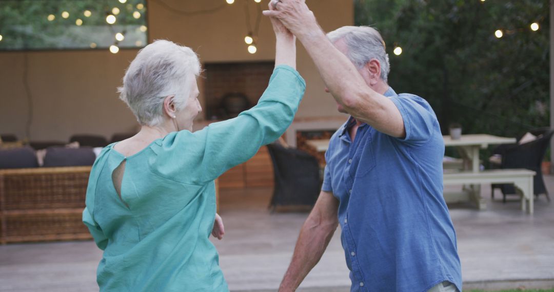 Happy Elderly Couple Dancing Outdoors at Evening - Free Images, Stock Photos and Pictures on Pikwizard.com