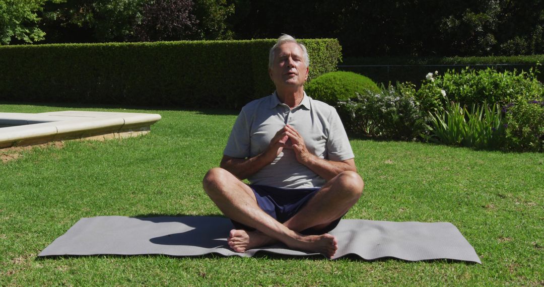 Caucasian senior man practicing yoga meditating in garden in the sun - Free Images, Stock Photos and Pictures on Pikwizard.com